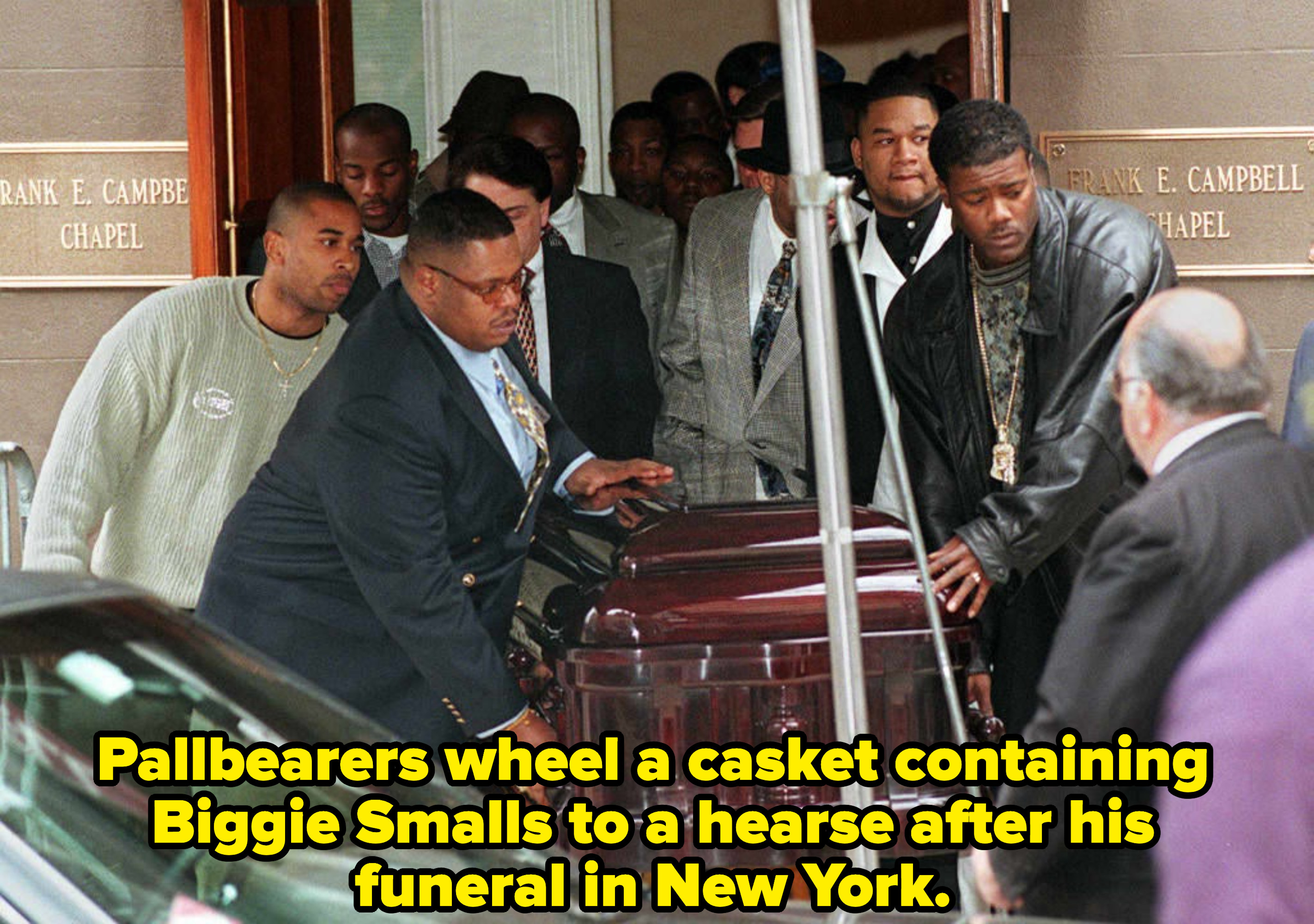 Pallbearers wheel casket containing rap star Biggie Smalls to hearse after funeral 18 March in New York