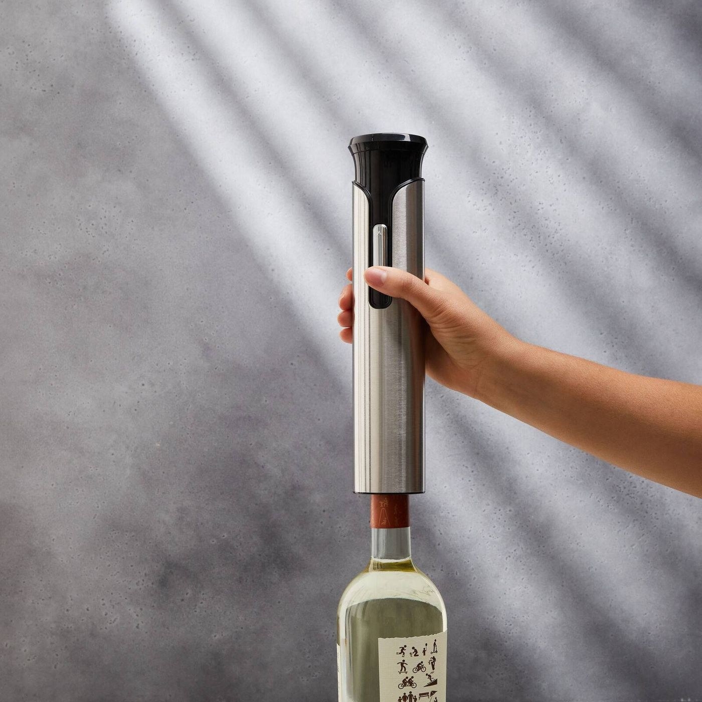 the stainless steel wine opener on a wine bottle