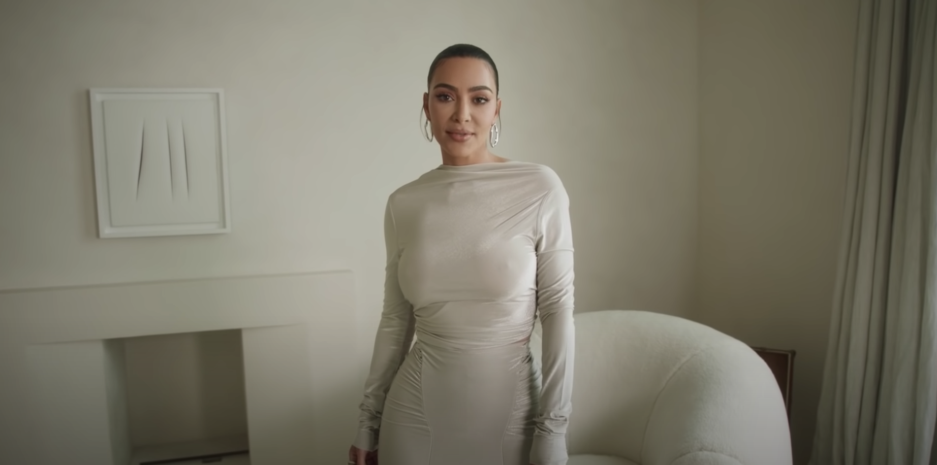 Kim K standing in her monotone living room