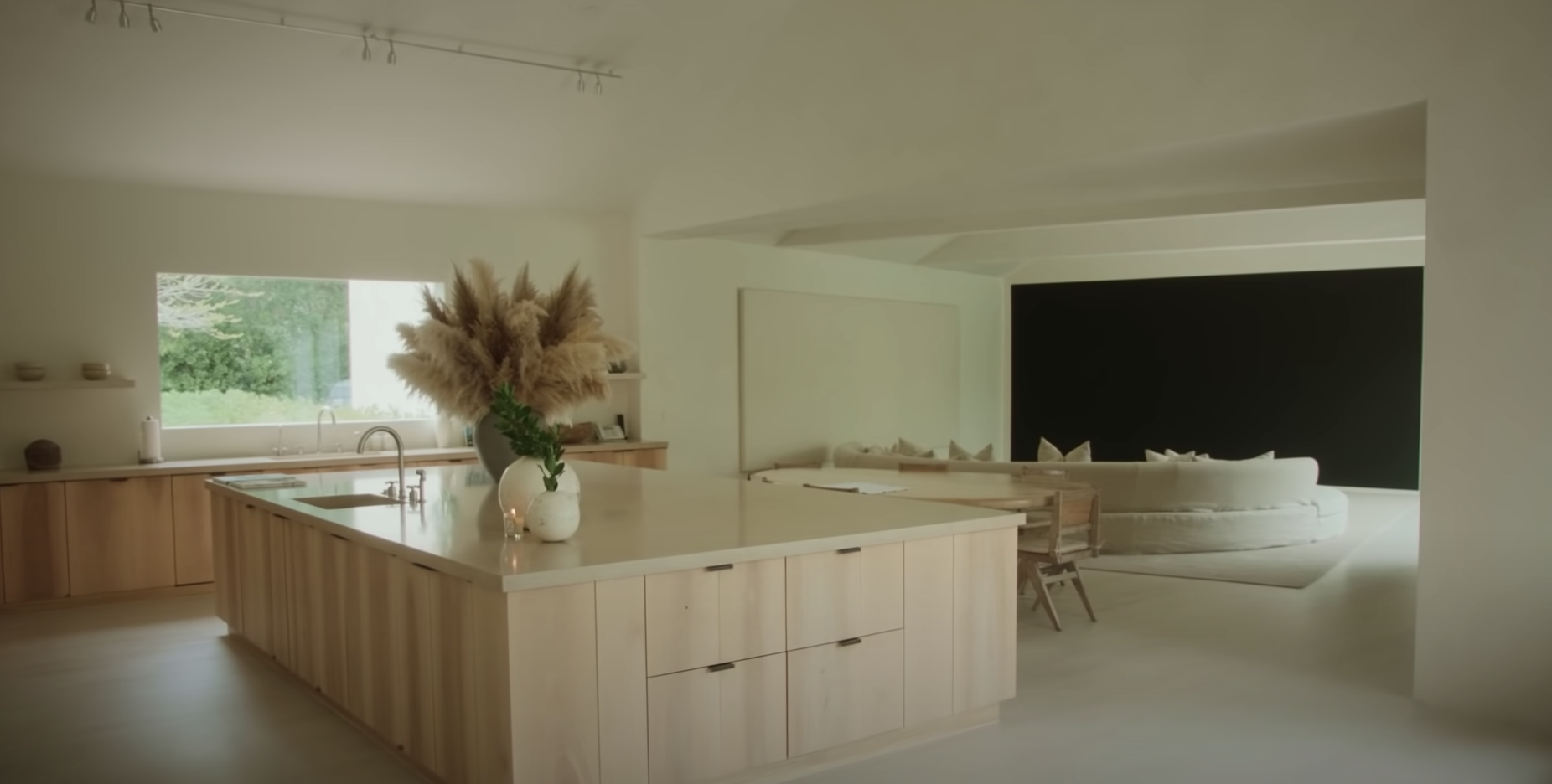 kitchen with a large block island with views into a sitting area