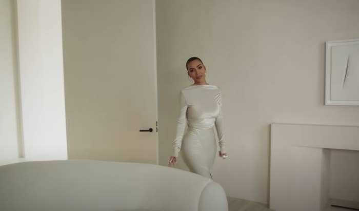 Kim in a white dress in her all-white home