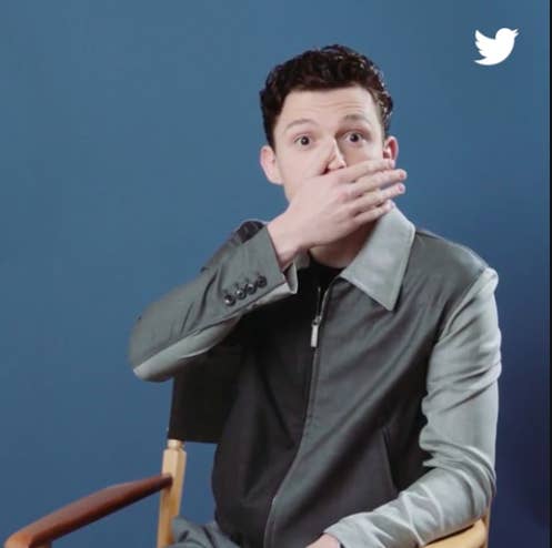 Tom Holland with a hand over his mouth