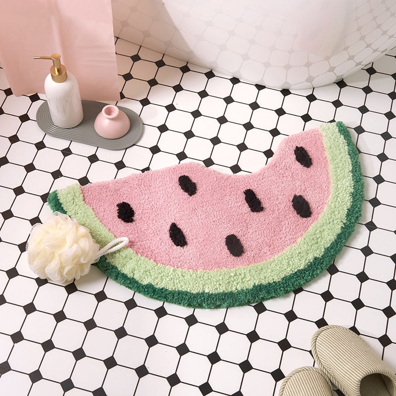 the watermelon bathmat on the floor of a bathroom