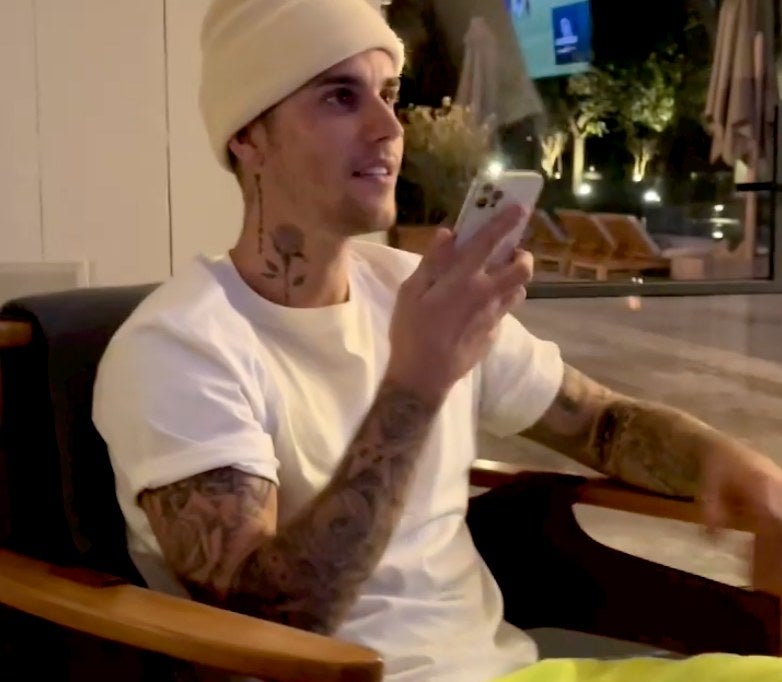 Justin talks on the phone while sitting in his living room