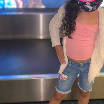 A child wearing the iridescent pink sneaker