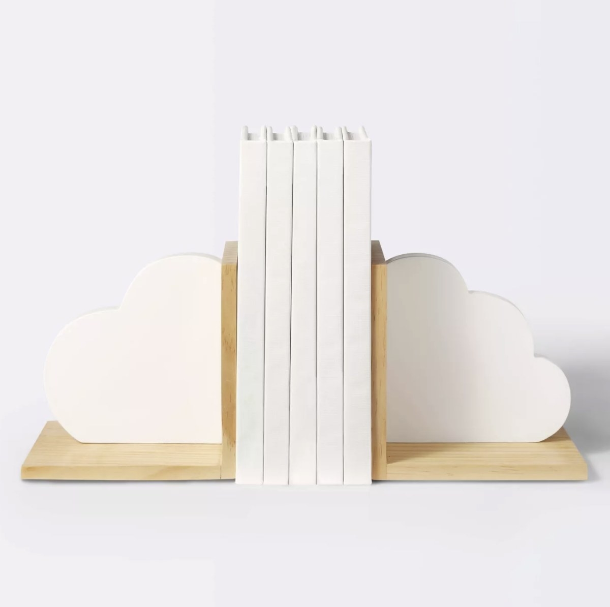 The white cloud bookends have a light wood base and are supporting five white books