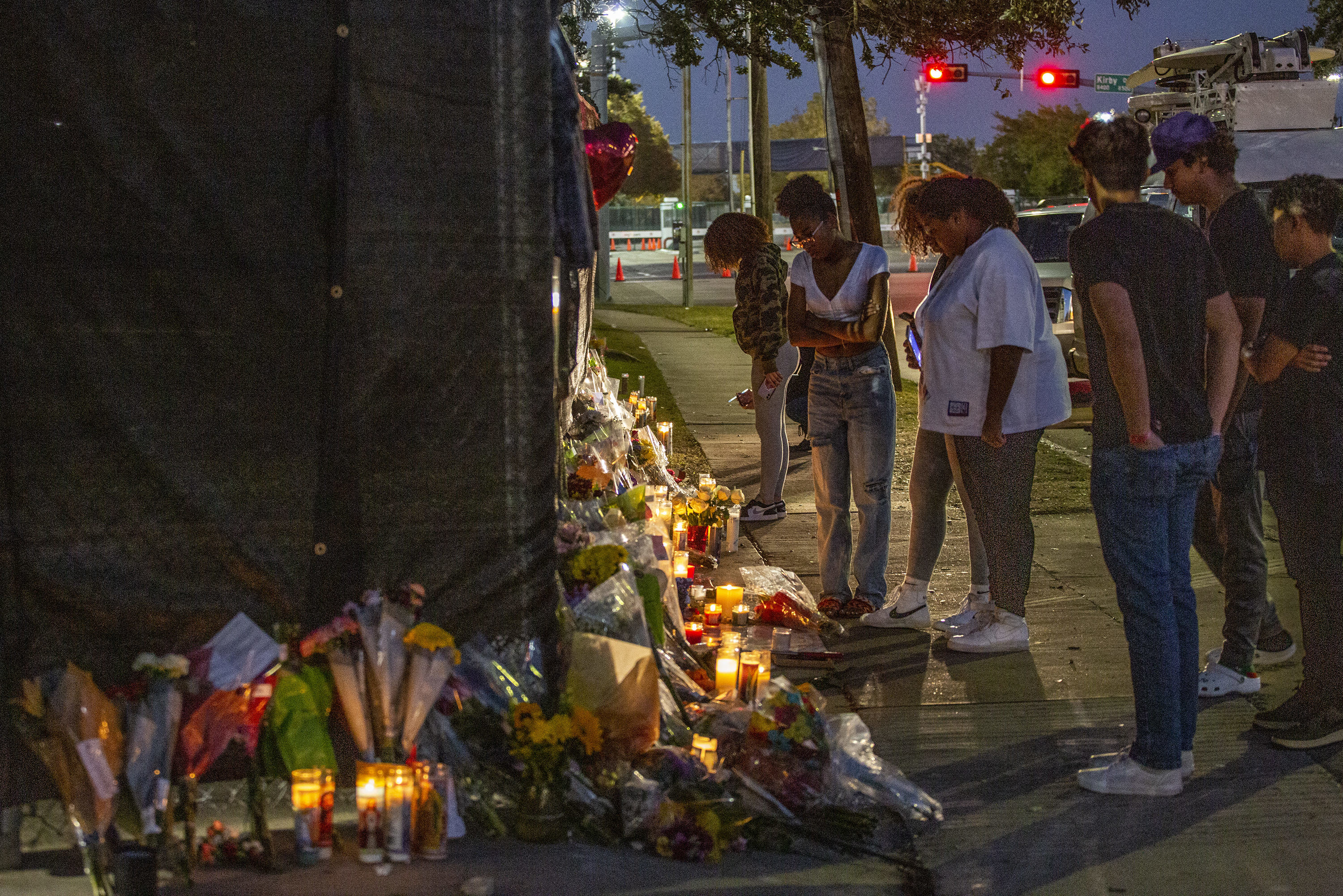 People attend a makeshift memorial on November 7, 2021 at the NRG Park grounds where ten people died in a crowd surge at the Astroworld Festival in Houston, Texas.