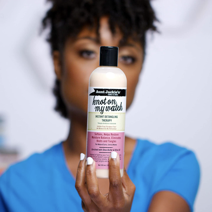 person holding bottle of detangler