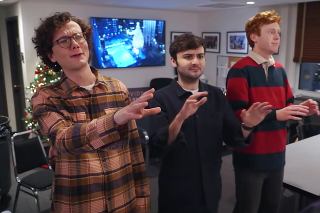 Martin, John, and Ben from Please Don't Destroy standing wit their hands up in a whoa, whoa, whoa kind of way