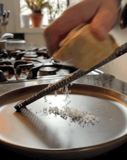Grating parmesan cheese on a microplane