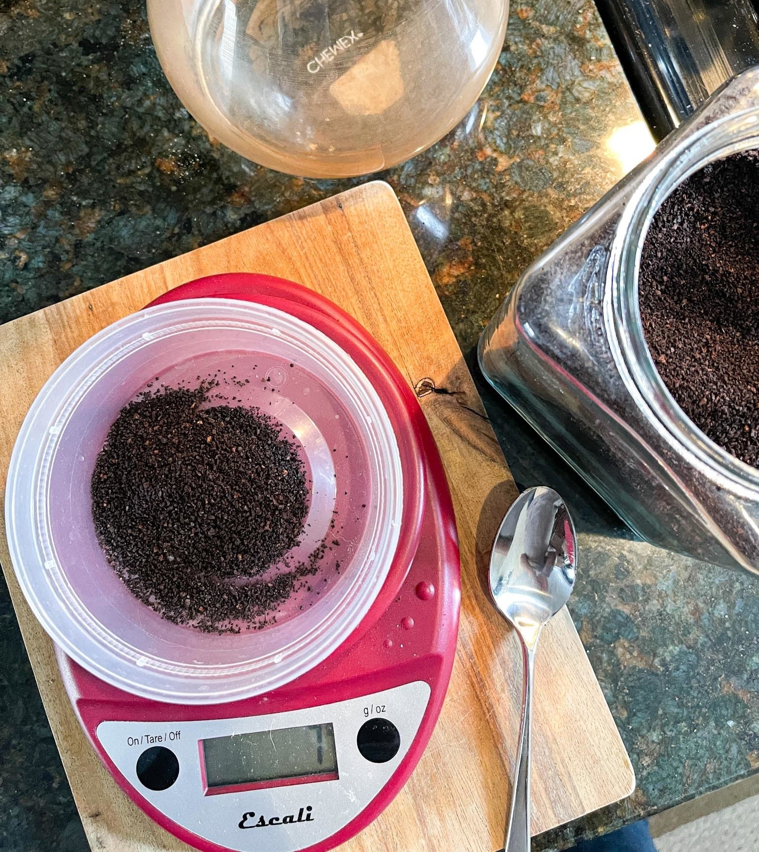 Kitchen scale being used to measure coffee