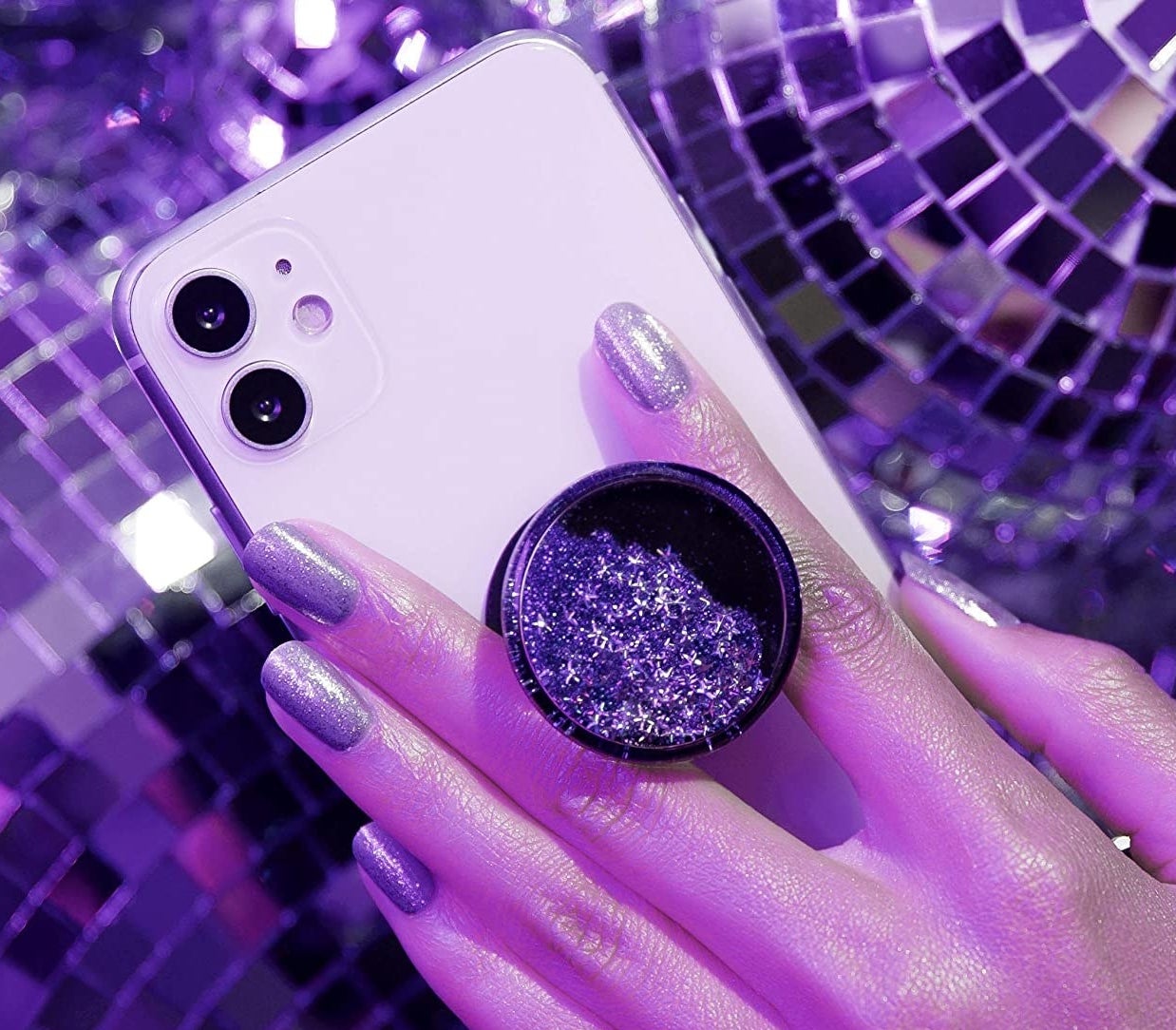 someone holding the glittery phone grip