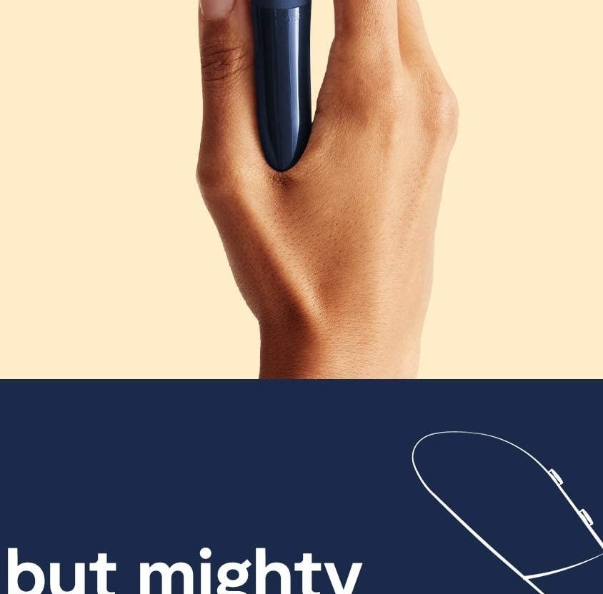 A person holding the vibrator between their thumb and index finger
