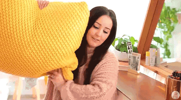 Tasha Leelyn hugging her pillow at home