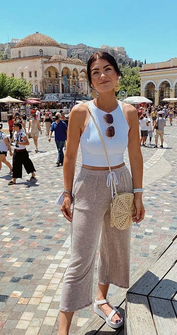 reviewer wearing the white cropped tank