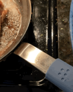 Chicken breasts cooking in a carbon steel pan