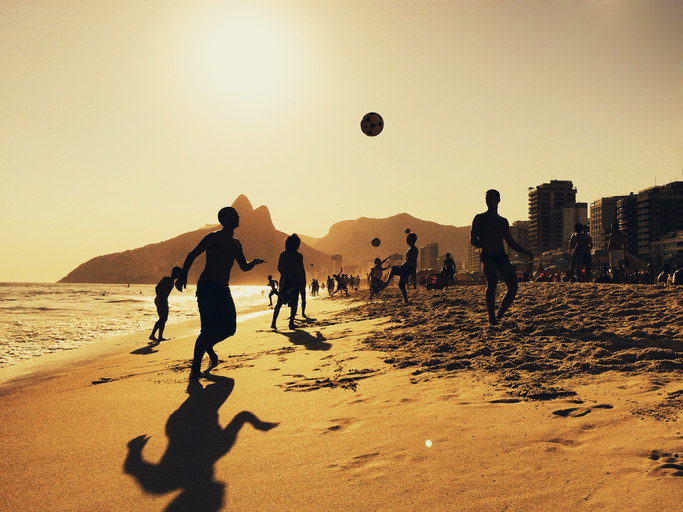 People playing football on Ipanema beach in Rio.