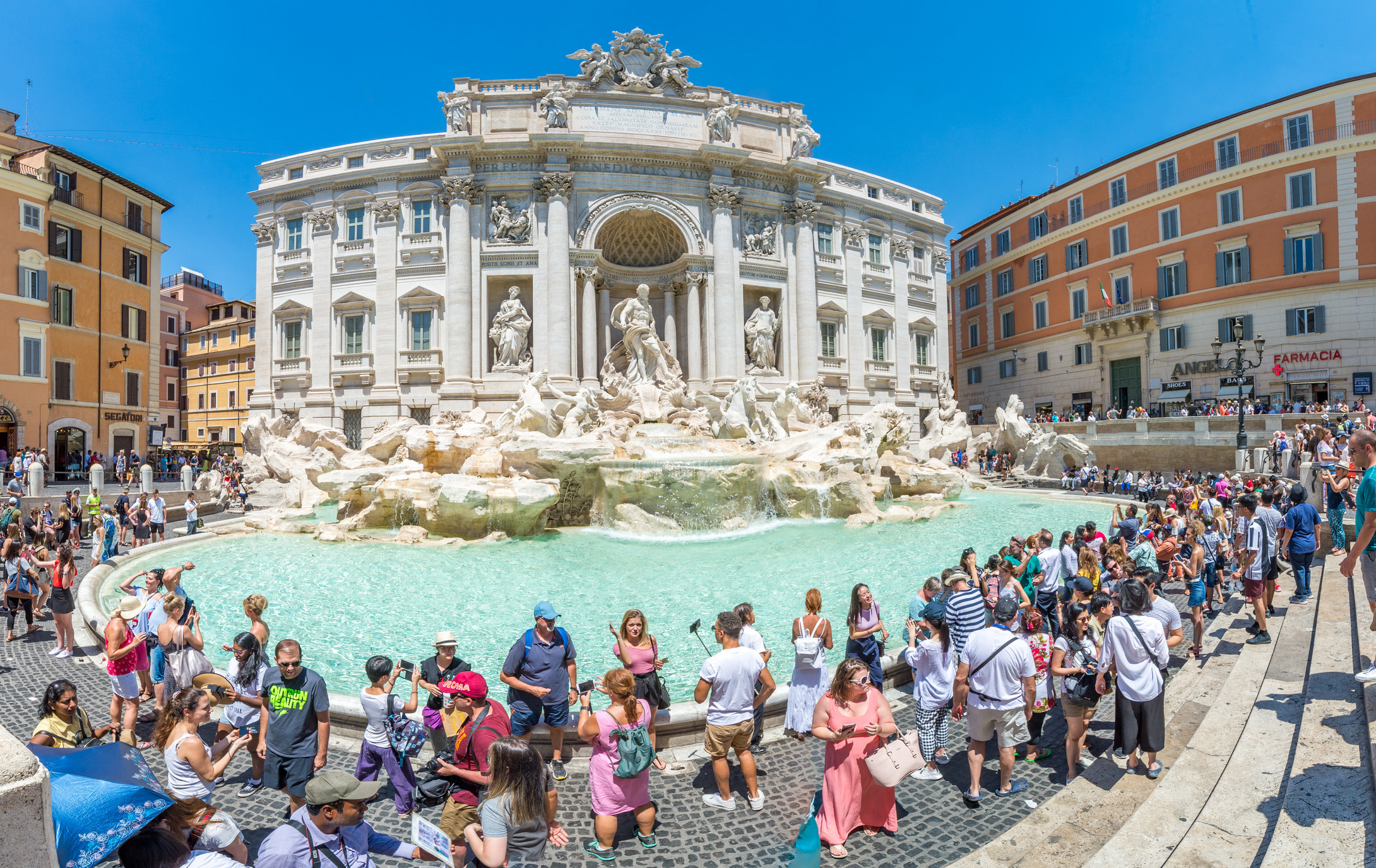 Trevi Fountain surrounded by tourists.