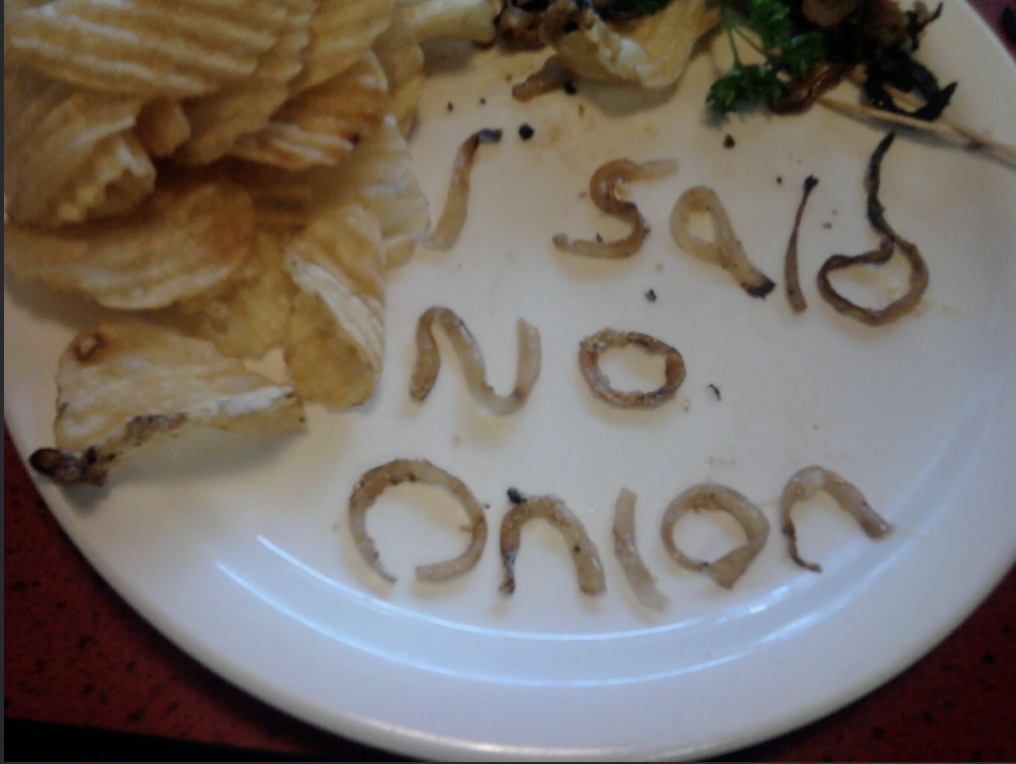 Someone spelled out i said no onions with onions on a plate