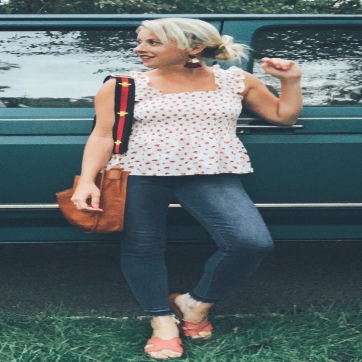 reviewer wearing the white smocked tank