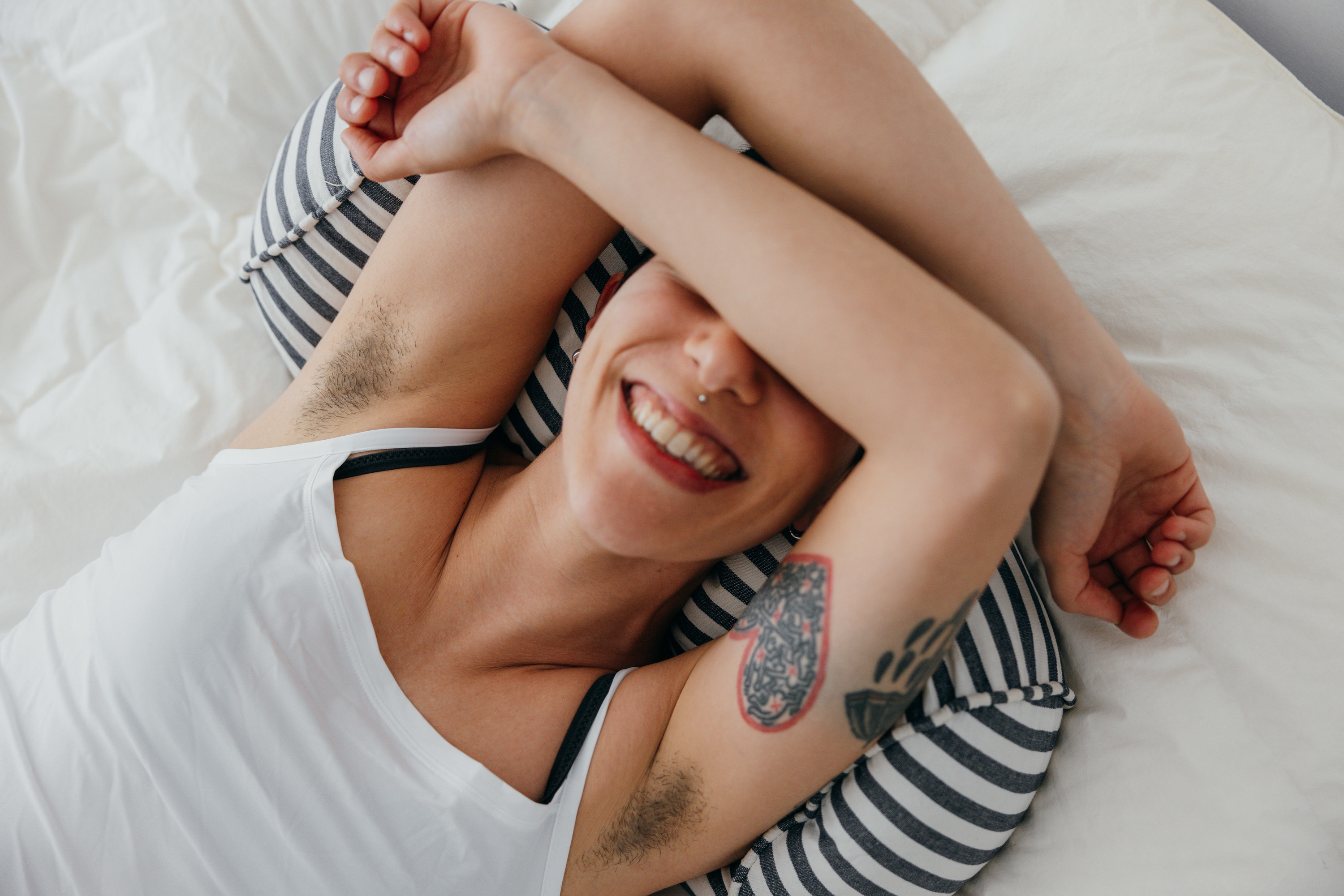 Smiling woman with hairy armpits