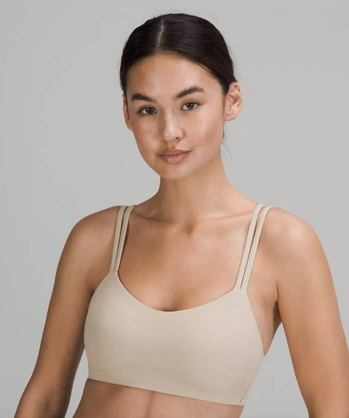a smiling person wearing the super soft sports bra
