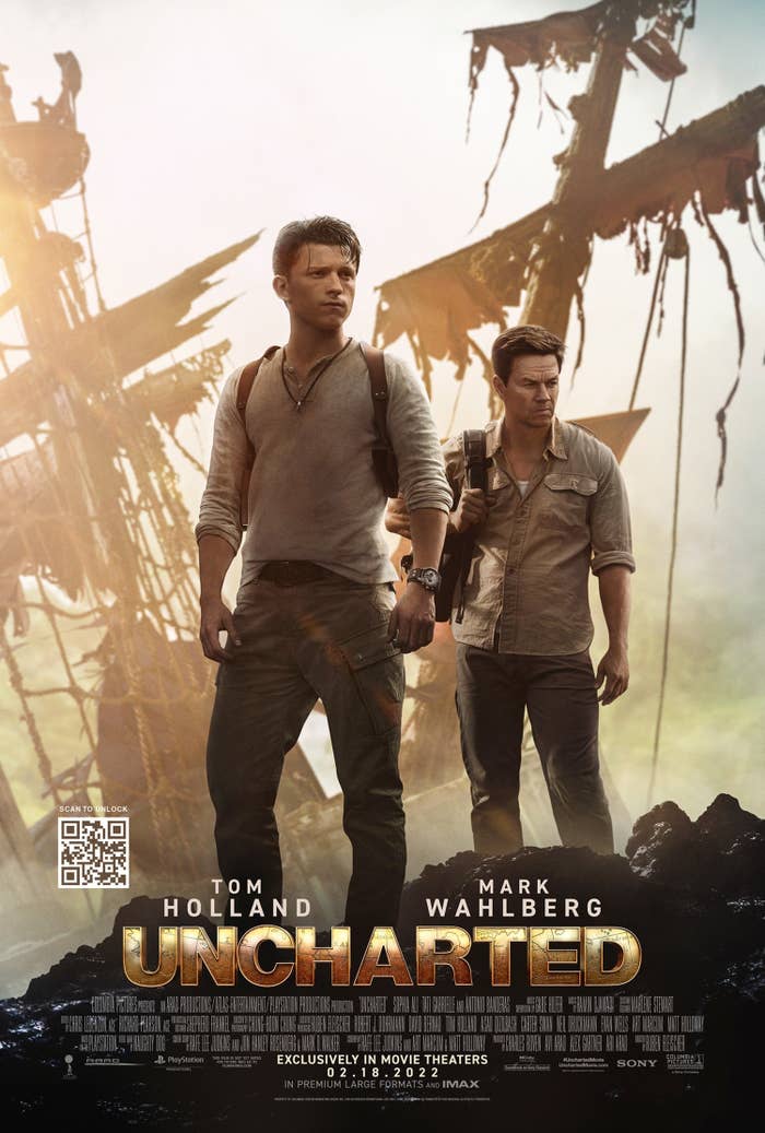A promo photo for the film featuring Tom and Mark standing on a rock formation with a ship in the background