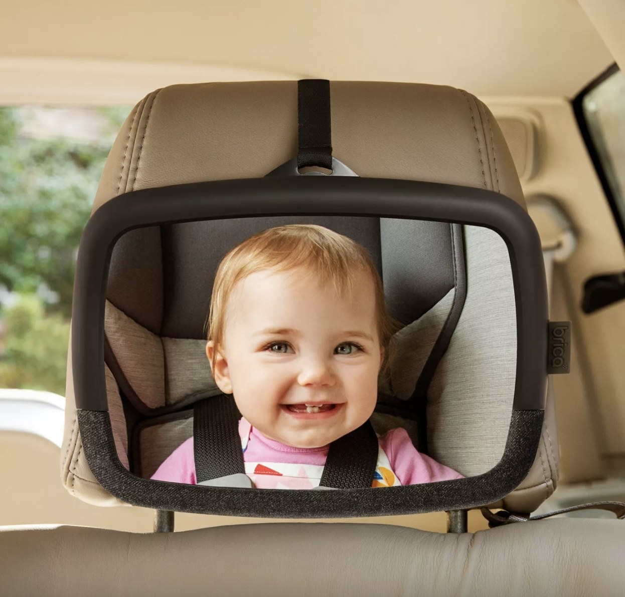 Baby looking in car seat mirror