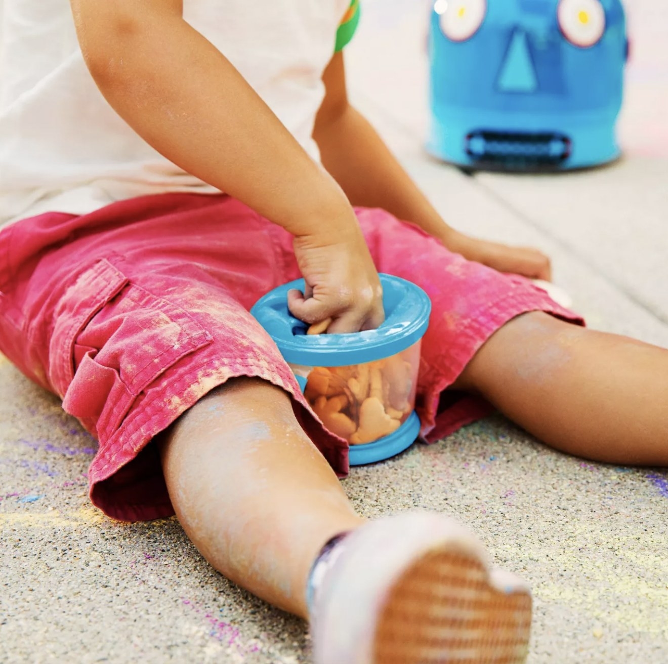 Kid eating snack out of snack catcher