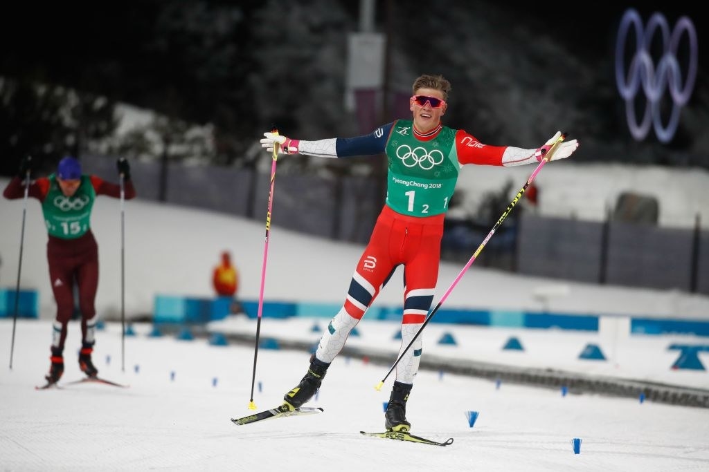 A skier celebrates after crossing the finish line