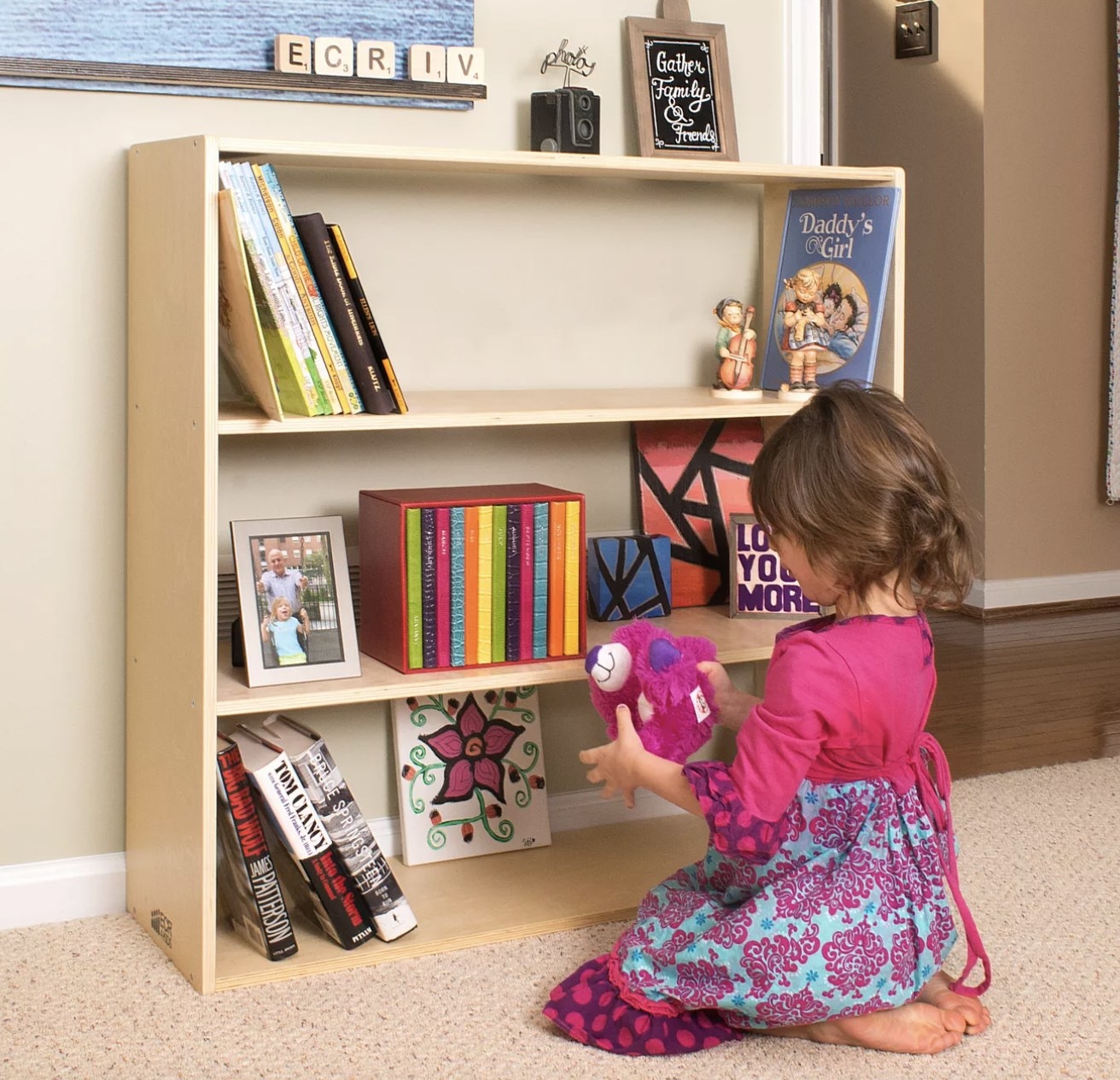Kid sitting at open shelf