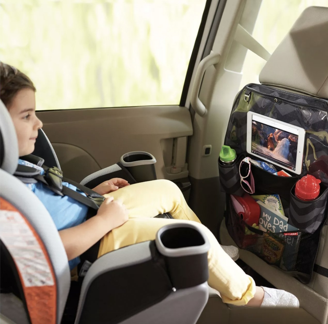 Kid watching tablet on the car organizer