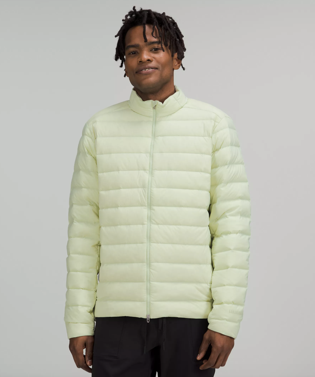 a smiling person wearing the quilted down jacket
