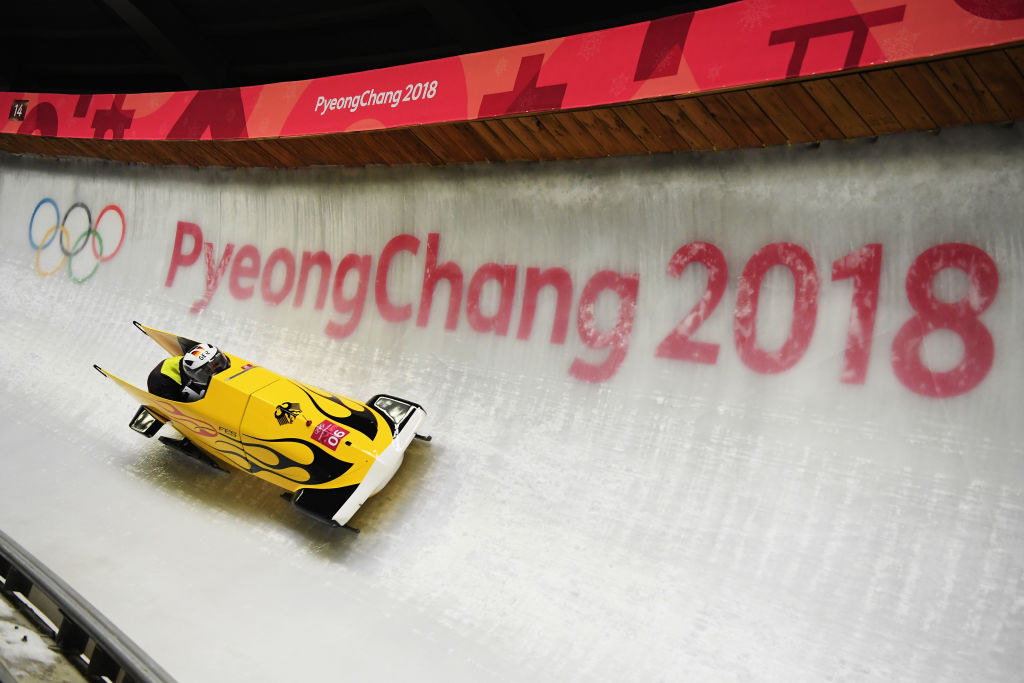 A two woman bobsled takes a corner in PyeongChang 2018