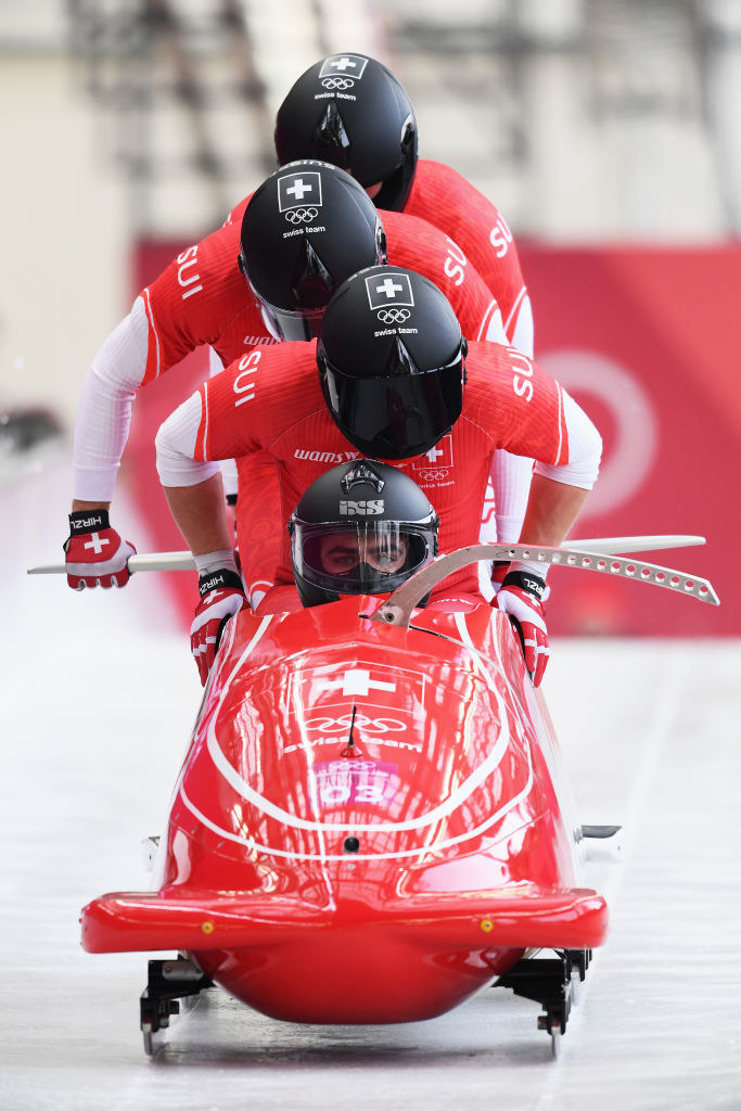 four people climb into the swiss bobsled