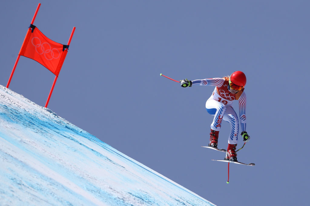 a skier gets in the air during a downhill event