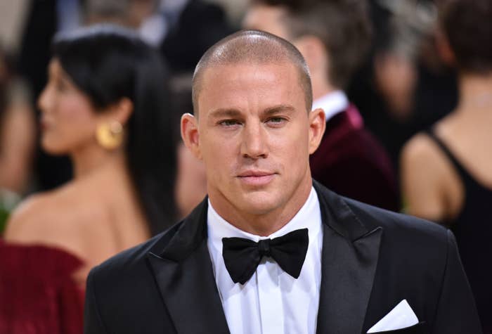 Tatum looks in the distance while at a red carpet event rocking a tuxedo