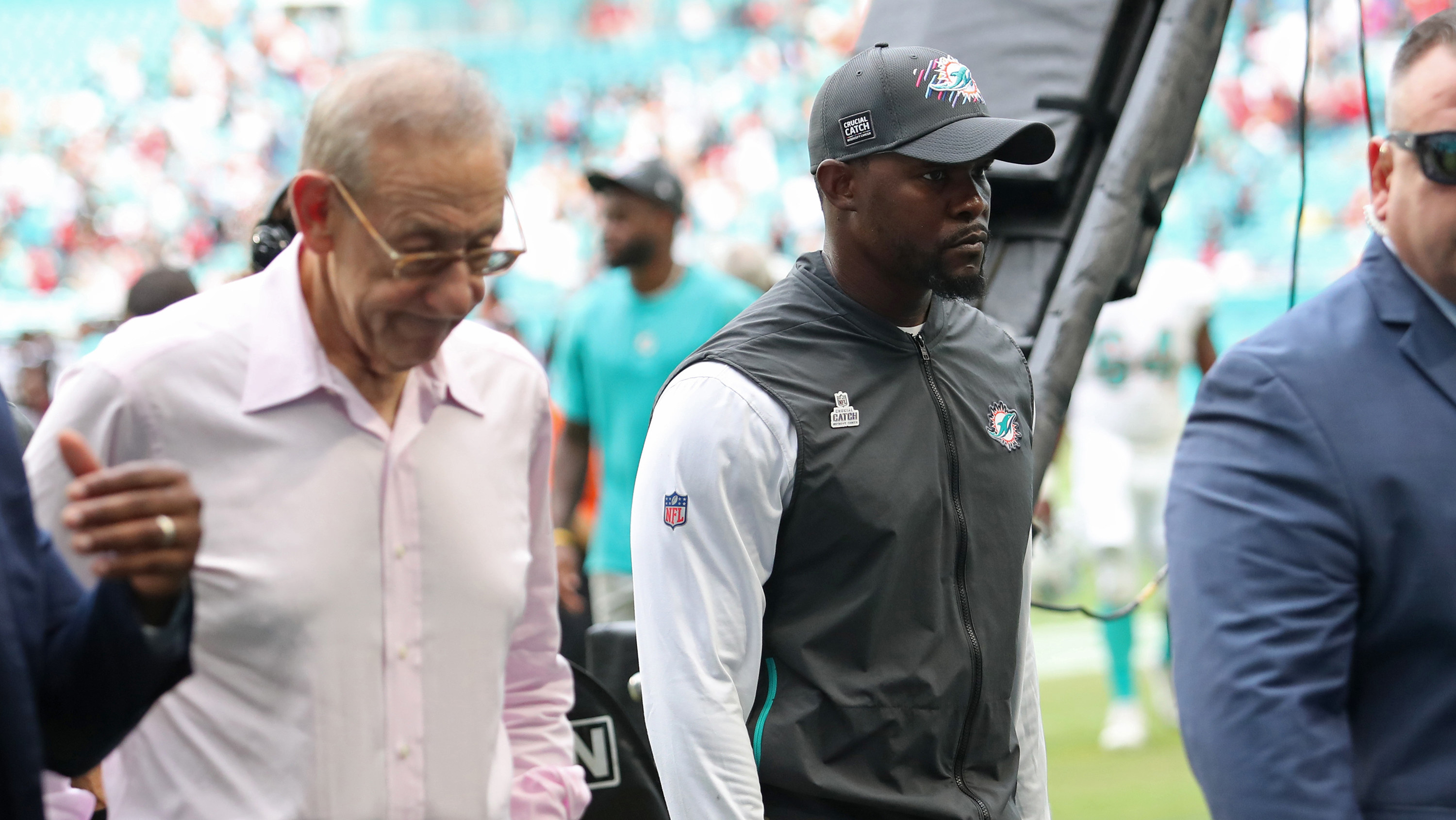 Owner of the Dolphins Stephen Ross and Brian Flores walking off the field together