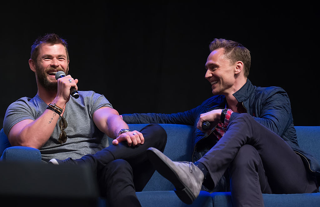 chris hemsworth and tom hiddleston laughing during an interview