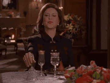 Emily Gilmore ringing a bell with her lips pursed