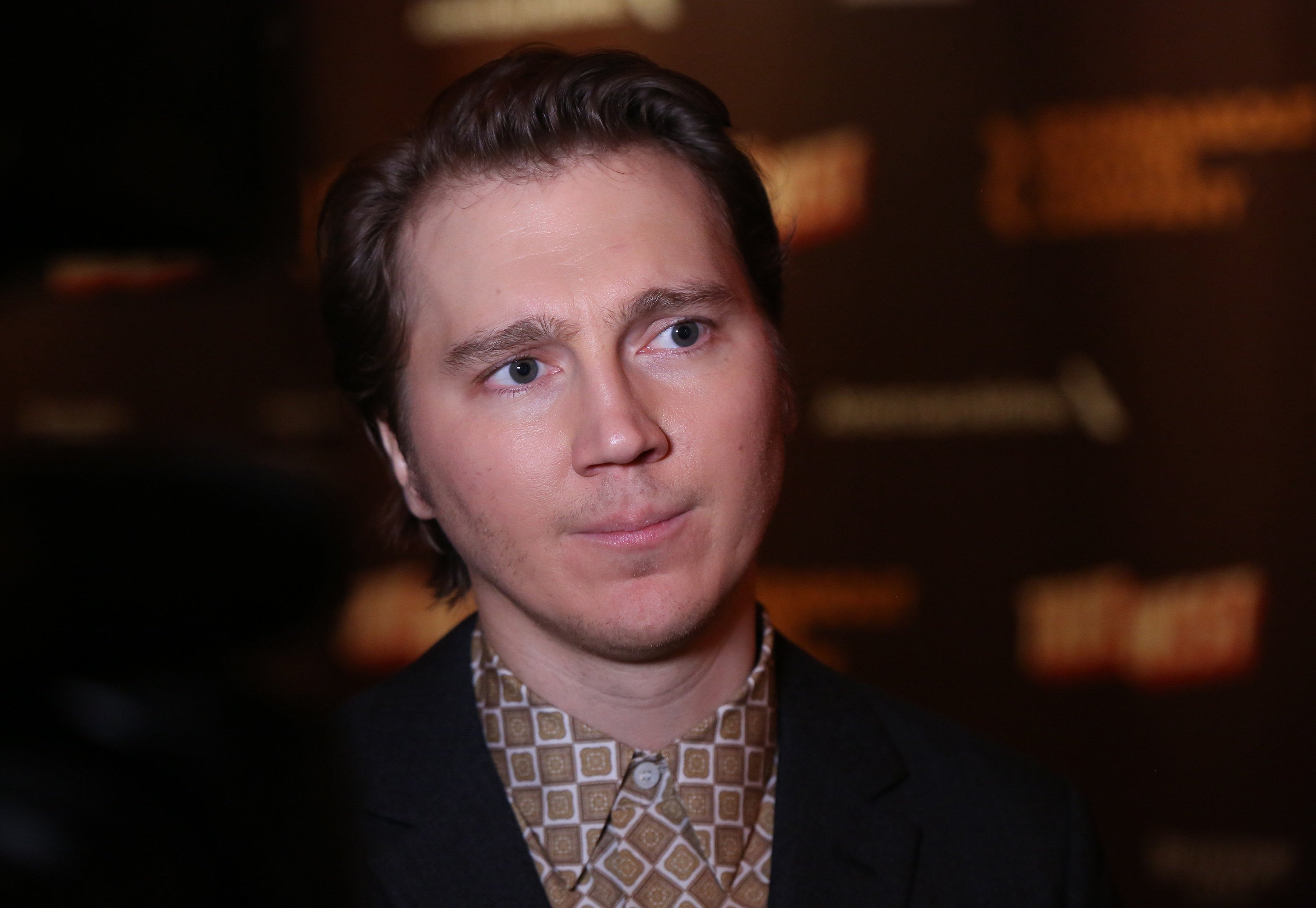 Dano looks at a camera