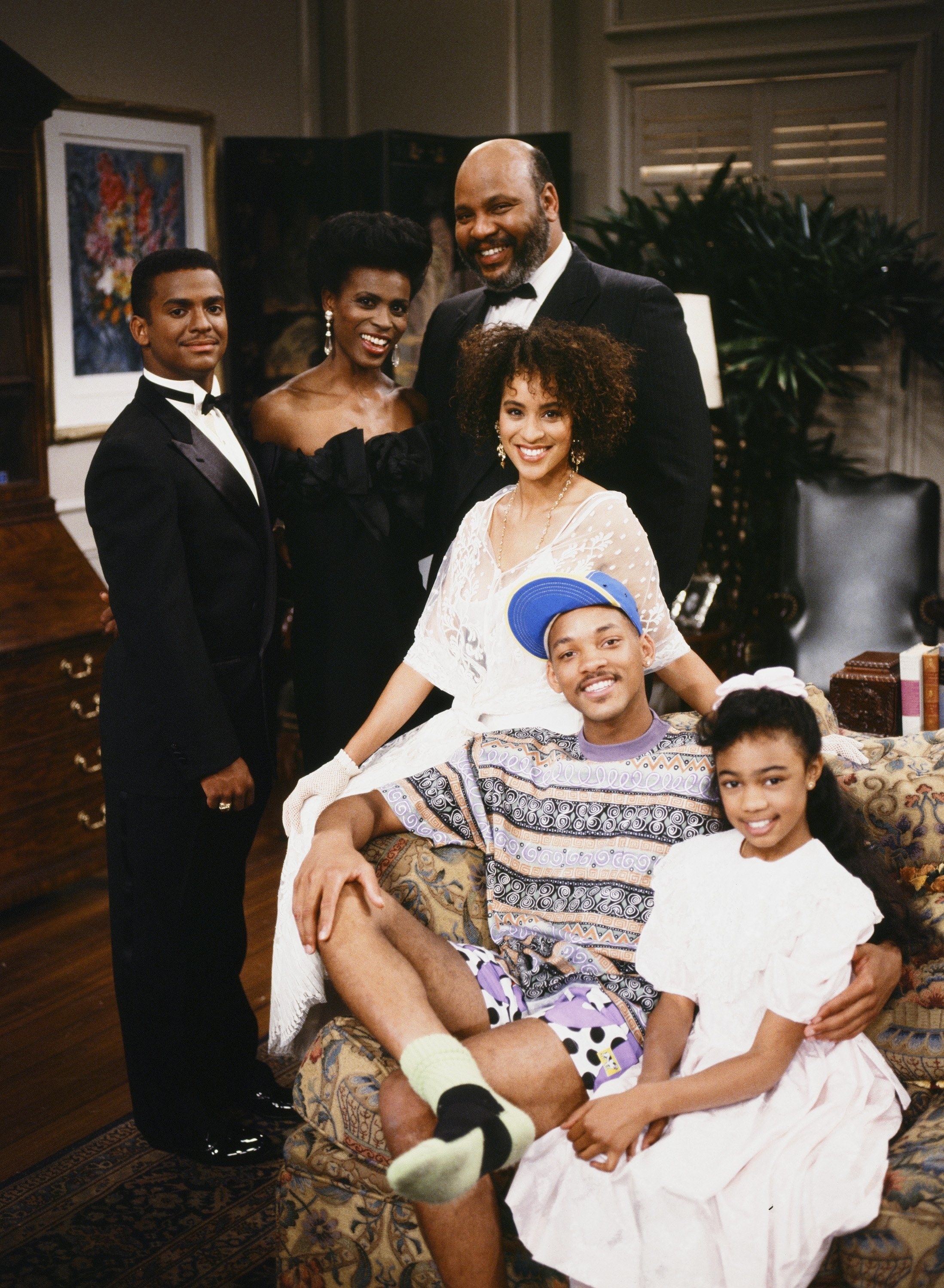 Members of the original cast of The Fresh Prince of Bel-Air pose together on set.