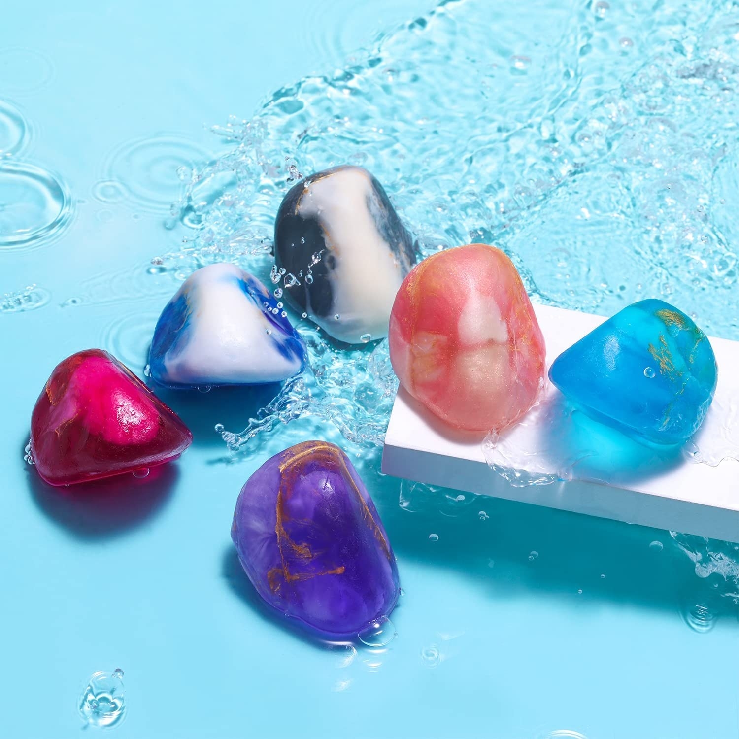 Six gemstone soaps in water