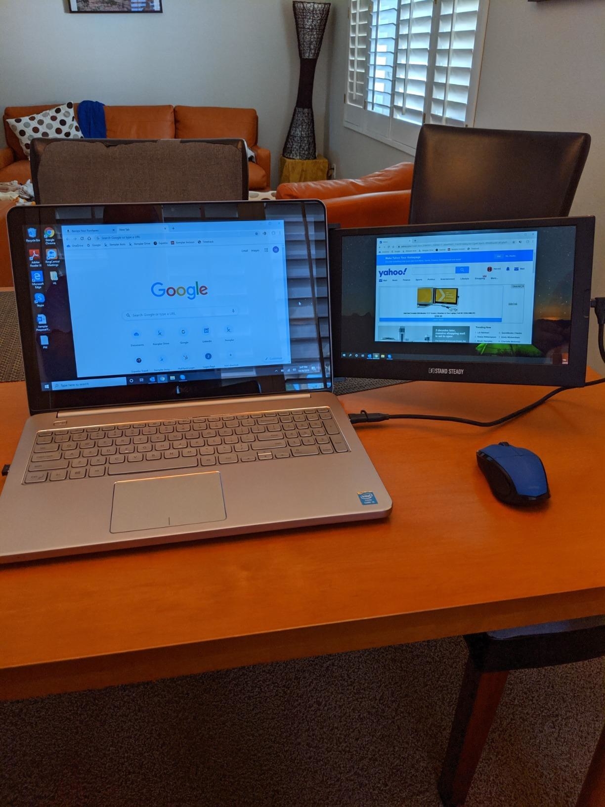 reviewer image of the dual monitor attached to their laptop on a desk