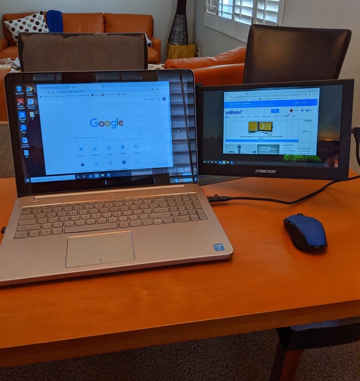 reviewer image of the dual monitor attached to their laptop on a desk