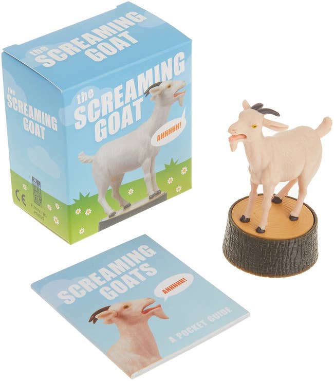 figure of screaming goat standing on stump with little booklet