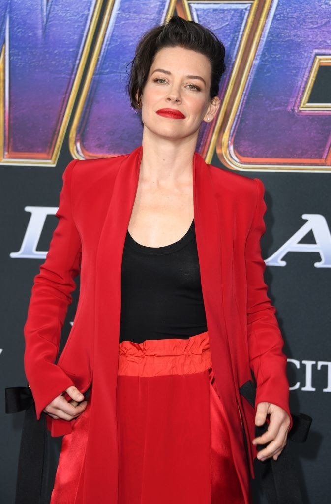dressed in a bold suit to match her lipstick, the actor poses on the red carpet