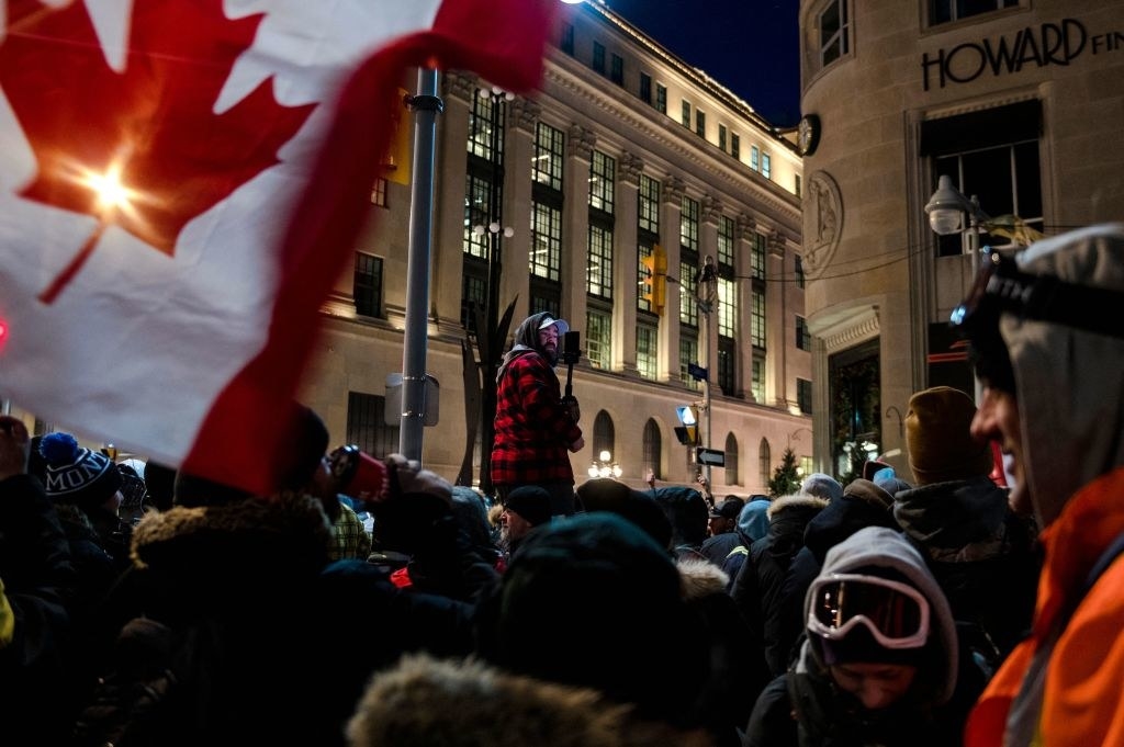 a crowd of protestors overtake a street in Ottawa