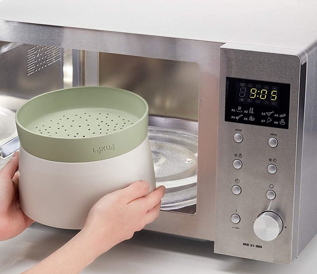 a person inserting the grain cooker into a microwave