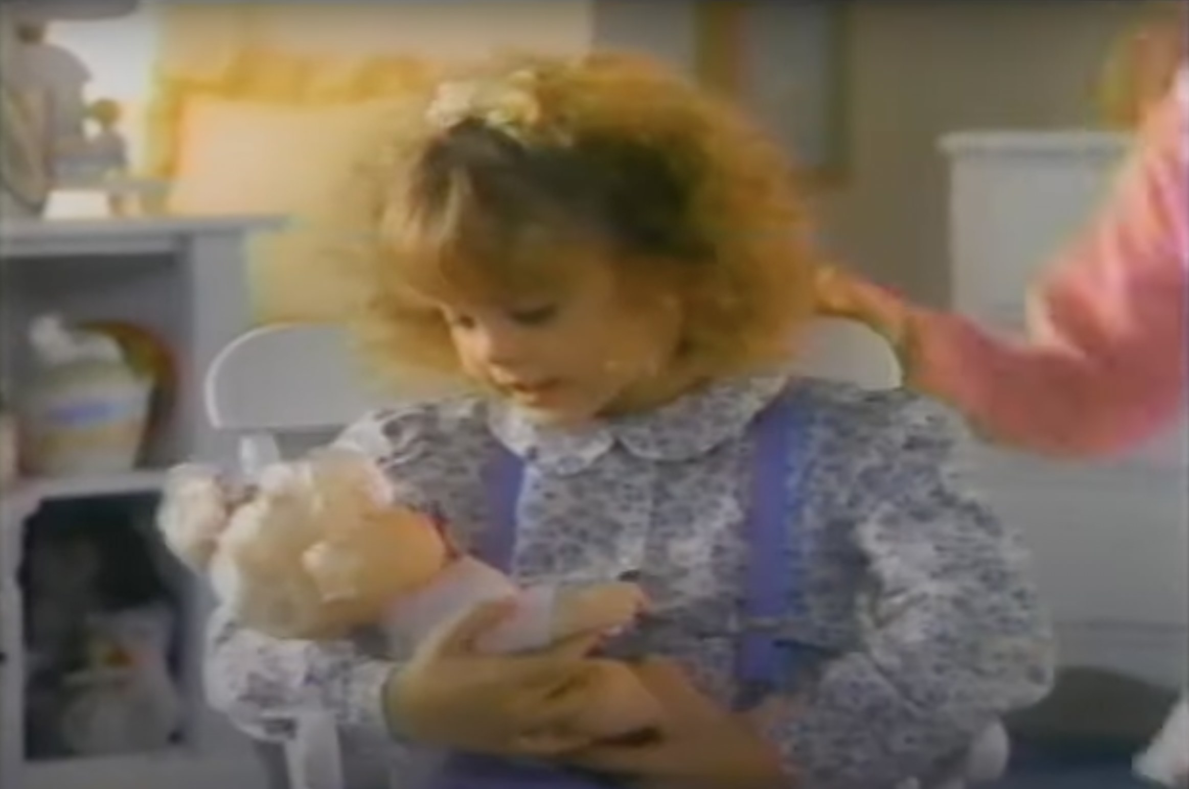 Kirsten Dunst cradling a baby doll
